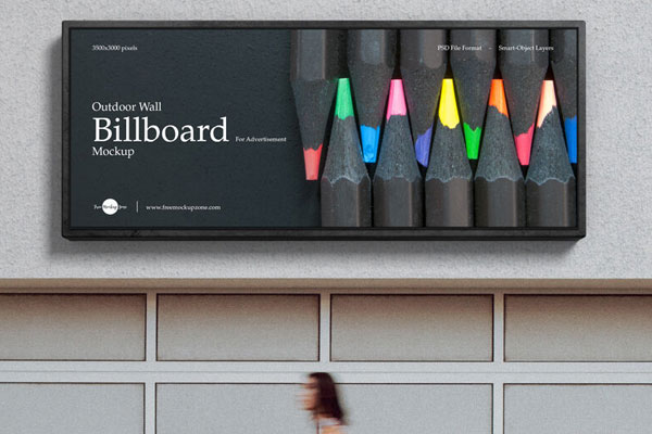 Outdoor Wall Billboard in the Front View Mockup Featuring a Woman Passing by