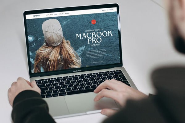 Over Shoulder View of a Man Working on MacBook Pro Mockup