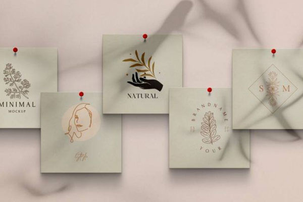 Overhead View of Five Square Papers Pinned to Wall Mockup