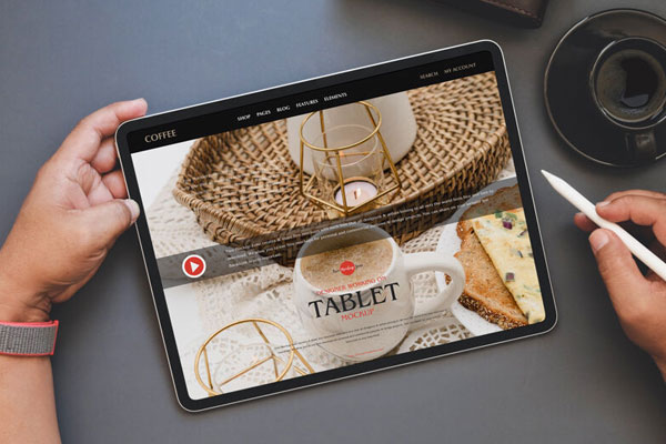 Overhead View of Hand Holding a Tablet and Electronic Pen Mockup