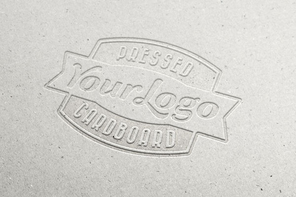 Overhead View of Logo on Cardboard with Letter Pressed Effect Mockup