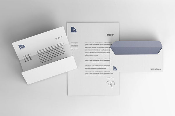 Overhead View of Opened and Folded Letterheads and Envelope Mockup