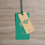 Overhead View of Two Cloth Tags on Wooden Surface Mockup