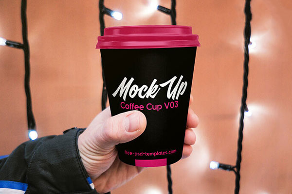 Paper Coffee Cup Held By Hand in the Front View Mockup