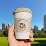 Paper Cup Sleeve in Hand Mockup