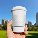 Paper Cup Sleeve in Hand Mockup