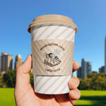 Paper Cup Sleeve in Hand Mockup