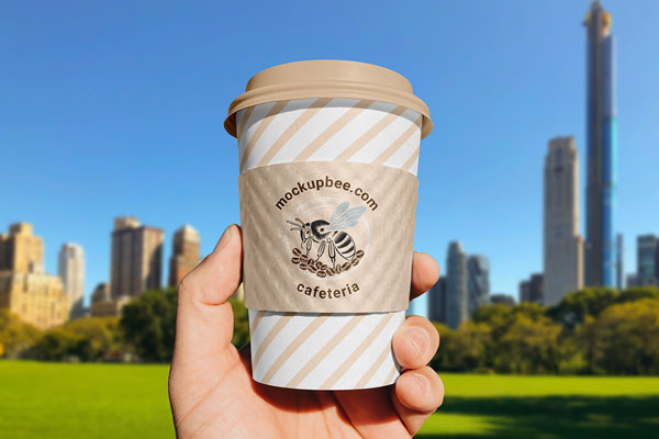 Paper Cup Sleeve in Hand Mockup