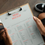 Perspective Showcase of Menu Mockup on Clipboard in Hands