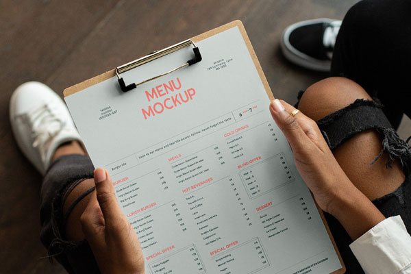 Perspective Showcase of Menu Mockup on Clipboard in Hands