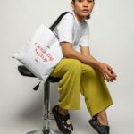 Perspective Sight of Sitting Woman Wears Canvas Bag Mockup