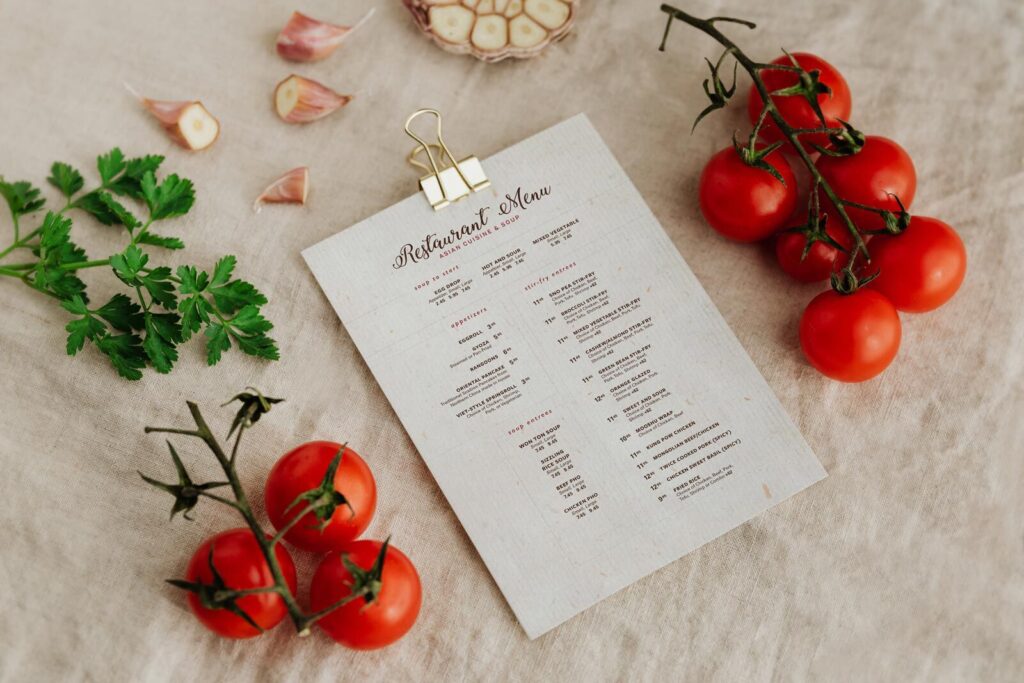 Perspective View A4 Menu Among Food Ingredients on Fabric Mockup