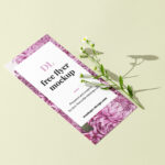 Perspective View DL-Size Flyer With Flower on Clean Surface Mockup