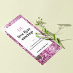Perspective View DL-Size Flyer With Flower on Clean Surface Mockup