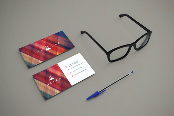 Perspective View Mockup of Two Business Cards with Glasses and Pen