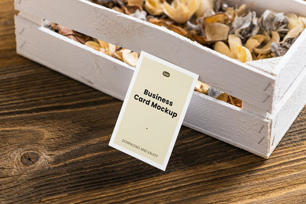 Perspective View of a Business Card Mockup Leaning on a Wooden Box