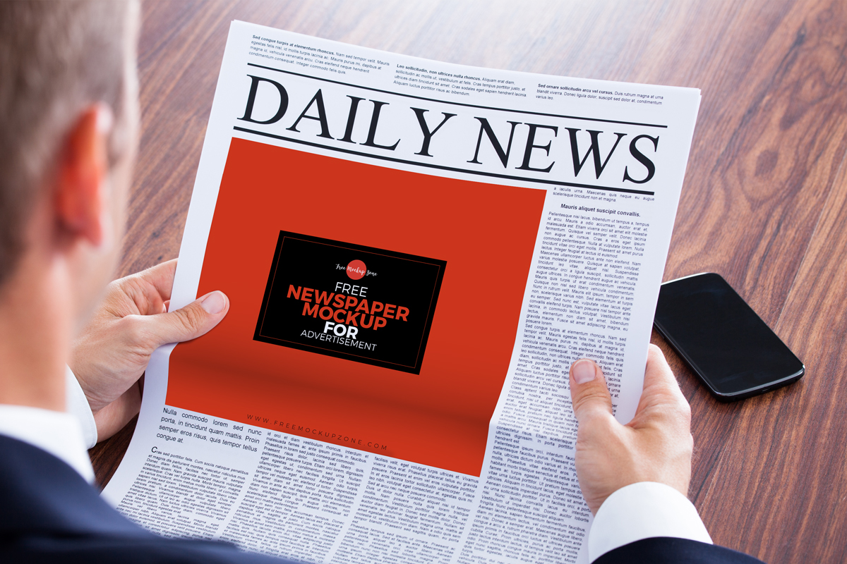 Perspective View of a Newspaper Ad in a Man's Hands Mockup FREE PSD