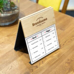 Perspective View of a Wooden Menu Mockup on Table