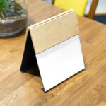 Perspective View of a Wooden Menu Mockup on Table