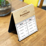 Perspective View of a Wooden Menu Mockup on Table