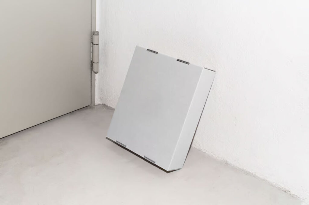 Perspective View of Cardboard Box Mockup Leaning against Wall