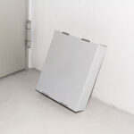 Perspective View of Cardboard Box Mockup Leaning against Wall