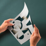 Perspective View of Glossy Paper Mockup in Hands