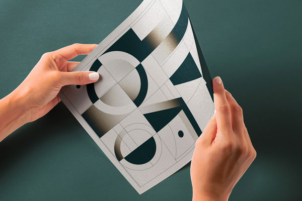 Perspective View of Glossy Paper Mockup in Hands
