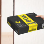 Perspective View of Hand Holding Mailing Box Mockup