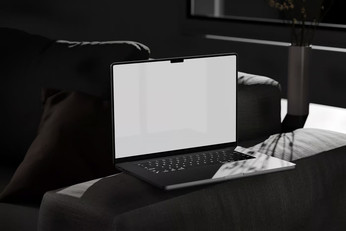 Free Perspective View of MacBook Pro Mockup on Settee PSD Template