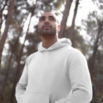 Perspective View of Man Wearing Hoodie Mockup Between Woods