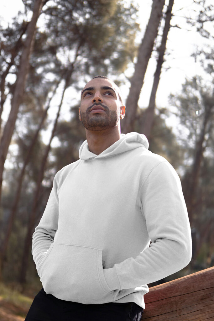 Perspective View of Man Wearing Hoodie Mockup Between Woods