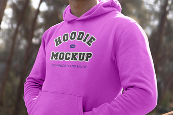 Perspective View of Man Wearing Hoodie Mockup Between Woods