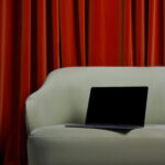 Perspective View of Modern MacBook Pro Mockup on Sofa