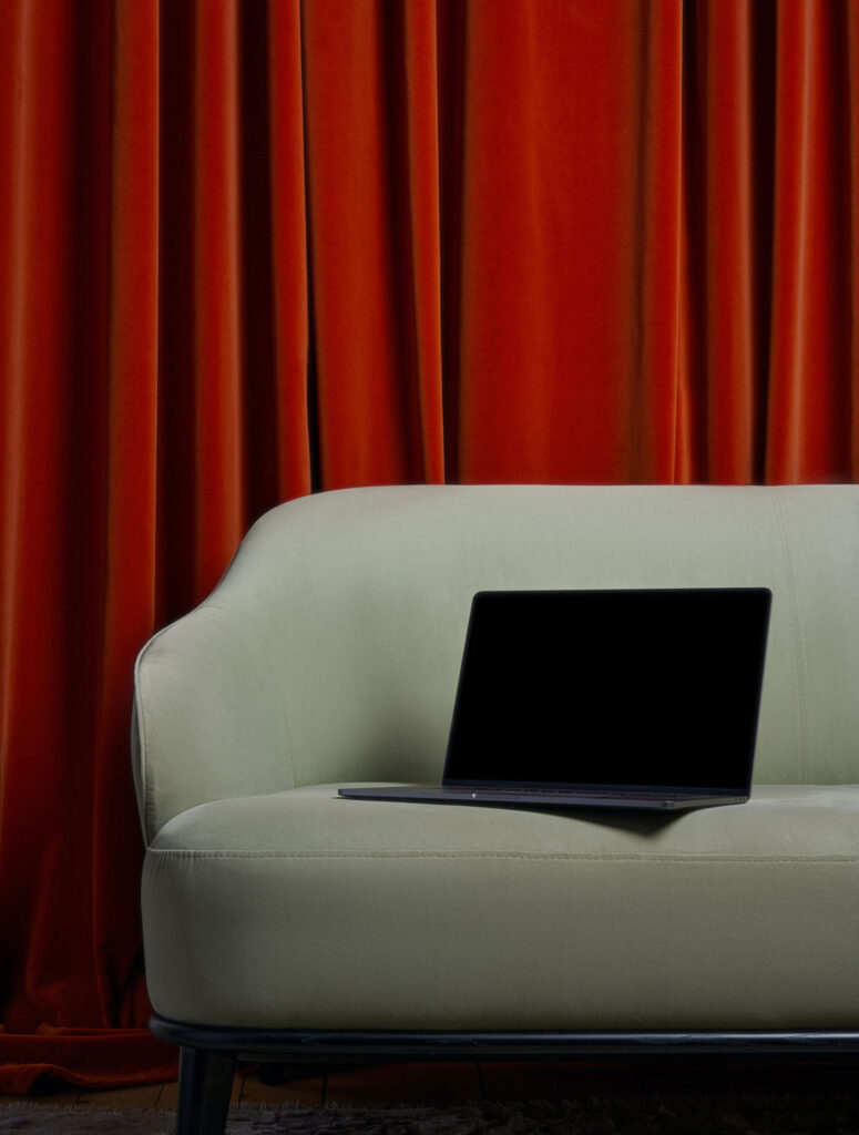 Perspective View of Modern MacBook Pro Mockup on Sofa