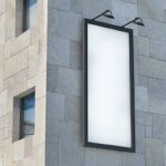 Perspective View of Outdoor Vertical Billboard Mockup on Building