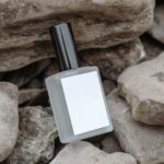 Perspective View of Perfume Bottle Mockup on Rocks
