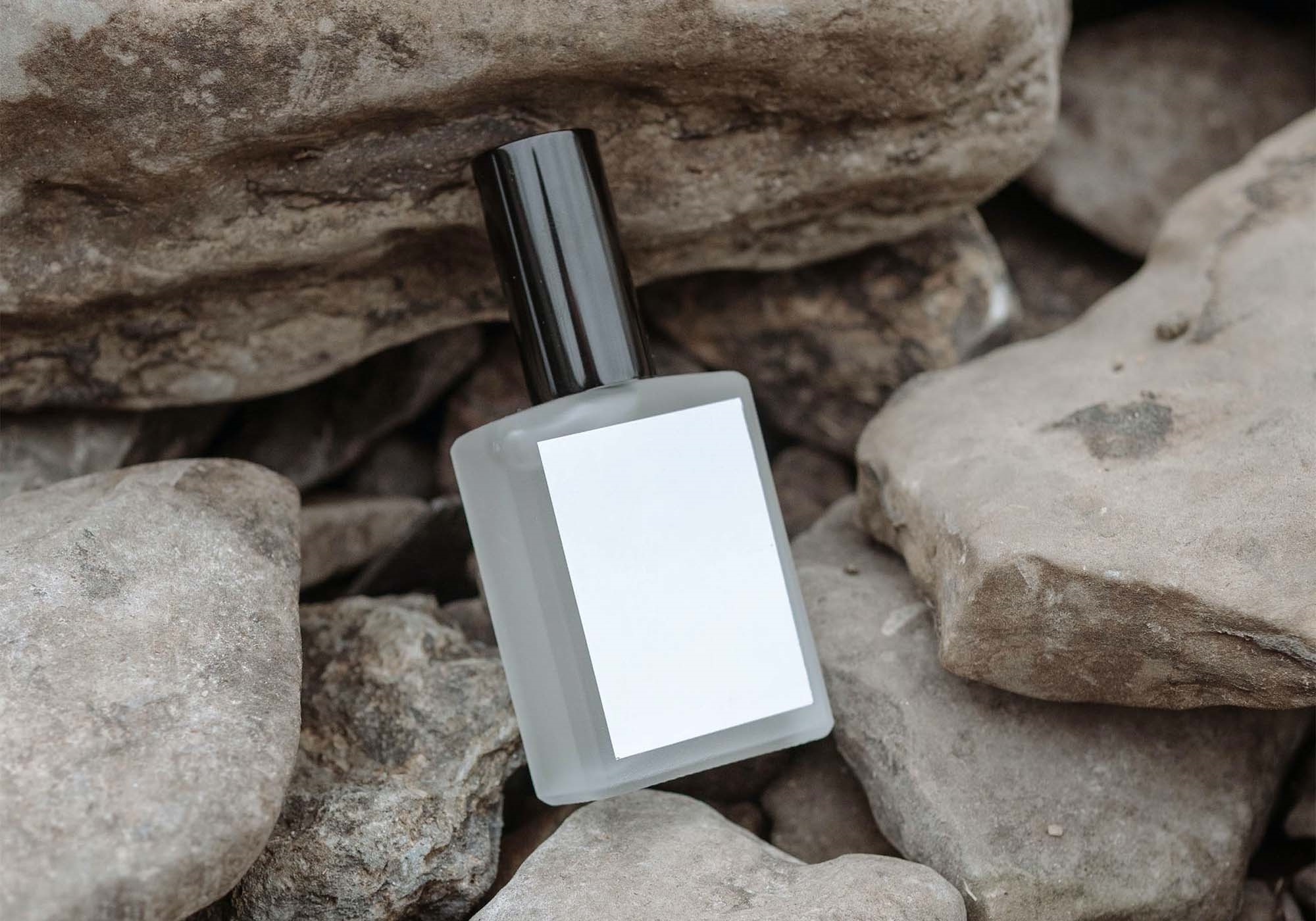 Perspective View of Perfume Bottle Mockup on Rocks FREE PSD
