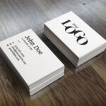 Perspective View of Two Packs of Business Card on Wooden Surface Mockup