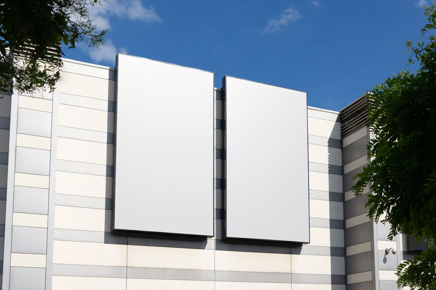 Free Perspective View of Vertical Billboards Mockup on Building PSD Template