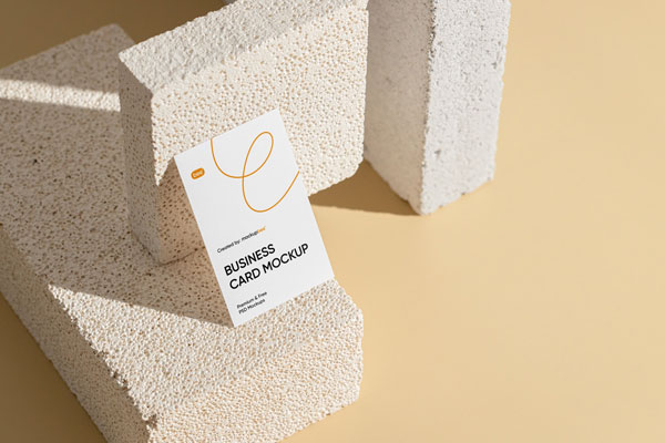 Perspective View of Vertical Business Card Mockup on Brick