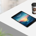 Perspective View Tablet on Table with Coffee Cup Mockup