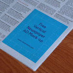 Perspective View Vertical Newspaper Ad on the Page Corner Mockup