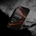 Perspective Vision of Black Titanium iPhone 16 Pro Mockup on Rock