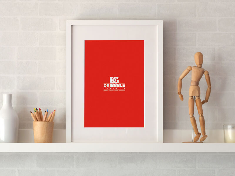 Photo Frame on a Shelf with Pencil and Statue Around Mockup
