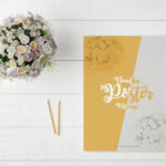Poster Mockup on Table with Pencils and Flowers
