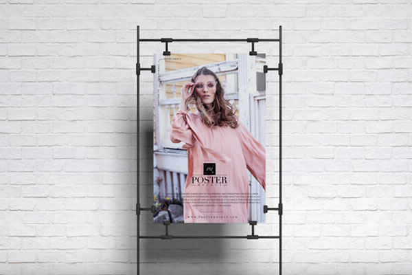 Poster on Sandwiched Clasps in Front of Brick Wall Mockup