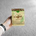 Realistic Mockup Featuring a Hand Holding a Small Coffee Bag