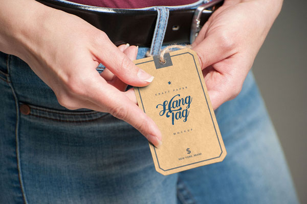 Realistic Mockup Featuring a Woman Holding a Hang Tag
