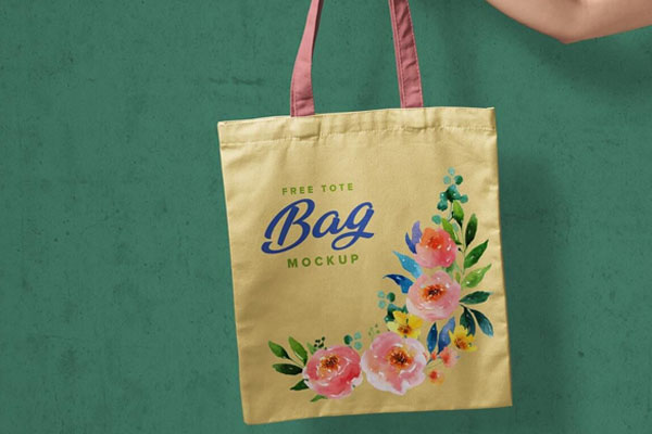 Realistic Mockup of Hand Holding a Tote Bag